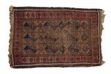 Antique Belouch rug with camel, aubergine, navy geometric serrated floral designs and blush border.