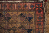 Corner detail of Antique Belouch rug, geometric floral field motifs and striated blush border.