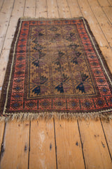 Antique Belouch rug corner detail: textured pile, ivory fringe, and blush geometric border.