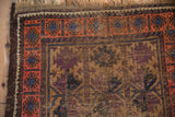 Antique Belouch rug: geometric blush border, aubergine field with varied pile.