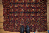 Fine antique Turkmen rug displaying elephant's footprint guls in burgundy, navy, worn edges.