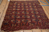 Tattered side and geometric border of an antique Turkmen rug, displaying elephant's footprint guls.