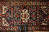 Traditional Persian Borchalou rug with detailed Herati fish pattern in navy, ivory, and blush.
