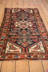 Central medallion flower with intricate Herati pattern in navy, ivory, red, and blue.