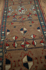 Northwest Persian rug detail: geometric pinwheel motifs in madder red and navy blue.