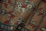 Hand-knotted antique Northwest Persian rug detail: camel field, pinwheel florals, madder red, navy.