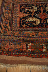 Geometric terracotta border and flat woven kilim of an antique Afshar rug.