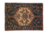 Fine Borchalou square rug with a stepped ivory medallion and pictorial motifs on a dusty navy blue field.