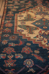 Angled view of the hand-knotted texture and stepped medallion on a vintage Borchalou rug.
