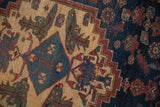Hand-knotted texture showing the stepped medallion corner and stylized motifs of a vintage Borchalou rug.