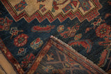 Folded corner of the vintage Borchalou rug reveals its dense hand-knotted foundation and secured edge.