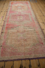 Full length perspective of a distressed Kurd runner highlighting its textured pink and silver pile.