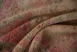 The short, even pile and hand-knotted texture of a distressed vintage Kurd rug runner.