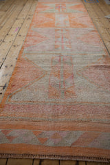Distressed texture and primitive geometric patterns in tangerine orange and ivory.