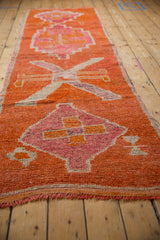 A vintage Kurd runner's textured pile and primitive medallions viewed from a low angle.
