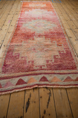Lengthwise perspective of the vintage Kurd runner highlighting its soft, textured pile and abrashed red and orange tones.
