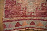 Geometric border of triangles and secured fringe on a distressed vintage Kurd runner's end.