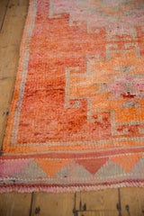Close-up of a vintage Kurd rug's hook and latch design in dusty raspberry and silver.