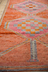 Distressed Kurd runner: vibrant checker motif with soft pile wear, tangerine, pink, faded purple.