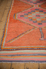 Distressed vintage Kurd runner pile texture with tangerine, pink, and purple checker motif.