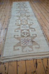 Long view of a distressed Kurd runner's dramatic starburst pattern in neutral tones.