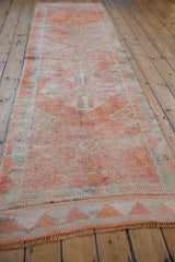 Distressed Kurd runner with textured pile, geometric medallions, and soft orange, beige tones.
