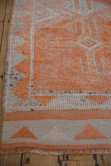 Vintage distressed Kurd rug runner with secured fringe and tangerine orange geometric border.