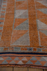 Distressed vintage Kurd rug, tangerine orange and muted beige geometric patterns with abrashes and fringe.