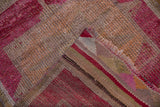 Distressed fuchsia and sand pile of a vintage Kurd runner, showing its striped flatweave reverse.