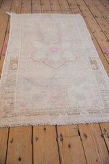 Low angle view showing the even wear and soft pile of a distressed vintage Oushak rug.