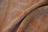 Distressed short pile texture of vintage Kurd rug in tone-on-tone orange and pink.