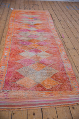 Full length perspective of the vintage Kurd runner, with a repeating diamond pattern in warm tones.