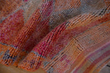The short, even pile and nubby hand-knotted texture of a vintage distressed Kurd rug runner.
