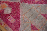 Distressed Kurd runner pile with visible knot heads, raspberry, ivory, and tangerine geometry.