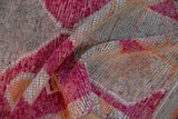 Distressed Kurd runner pile with raspberry, fuchsia, and tangerine geometric relief.