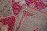 Fuchsia distressed pile and hand-knotted foundation of the vintage Kurd rug.