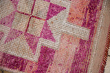 Distressed Kurd runner with textured fuchsia, blush geometric patterns and fringed edge.