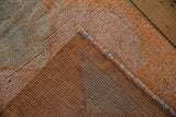 Distressed pile of the Kurd runner revealing its hand-knotted foundation and secured edge.