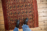 Geometric elephant's footprint guls in madder red, navy blue, and antique ivory on an antique Turkmen rug.