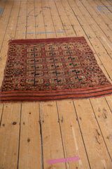 Patterned side border and geometric guls on antique Turkmen rug, madder red and navy.