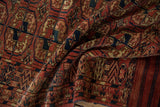 Fine antique Turkmen rug: folded pile texture with madder red and navy geometric guls.
