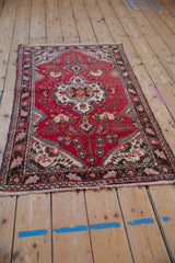 Corner of vintage Dargezine runner, showing its secured ends and chocolate floral border.