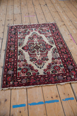Vintage Dargezine rug corner: ivory field, blush and black cherry red floral spandrel, navy border.