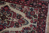 Vintage Dargezine rug with ivory field, dense red, blush, and blue floral motifs.