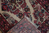 Folded vintage Persian Dargezine rug, showing red, blue floral pile and striped foundation.