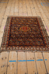Vintage Serbend rug detail: navy field with colorful Herati motif and boteh vine border.