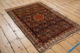 Navy field with intricate Herati motif and red boteh border on a vintage Serbend rug.