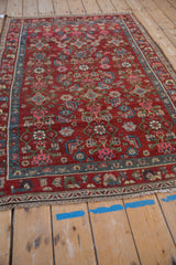Kurdish Hamadan rug's Herati field, floral border in red, blue, pink, olive, showing wear.