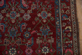 Black cherry red field with geometric Herati design and playful blossom main border.
