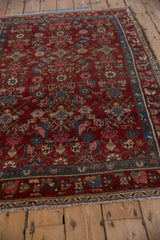 Black cherry red geometric Herati field meeting a sky blue and pink floral border.
